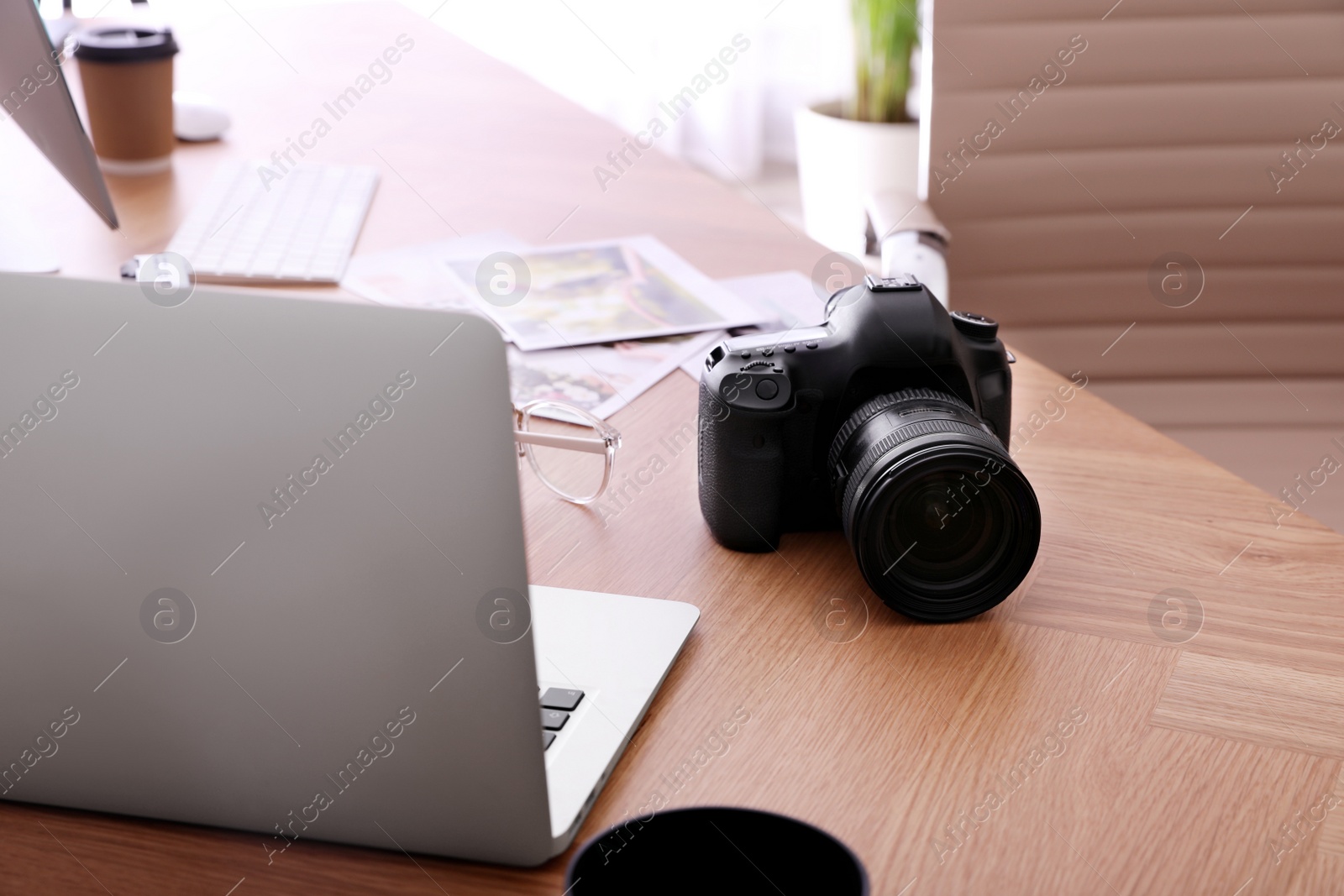 Photo of Photographer's workplace with professional camera in office