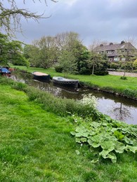 Canal with moored boats outdoors on cloudy day