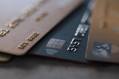 Photo of Plastic credit cards on table, macro view