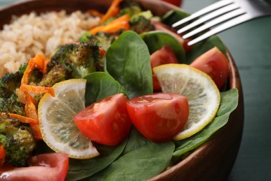 Tasty fried rice with vegetables in bowl, closeup