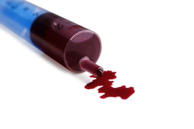 Photo of Plastic syringe with blood on white background