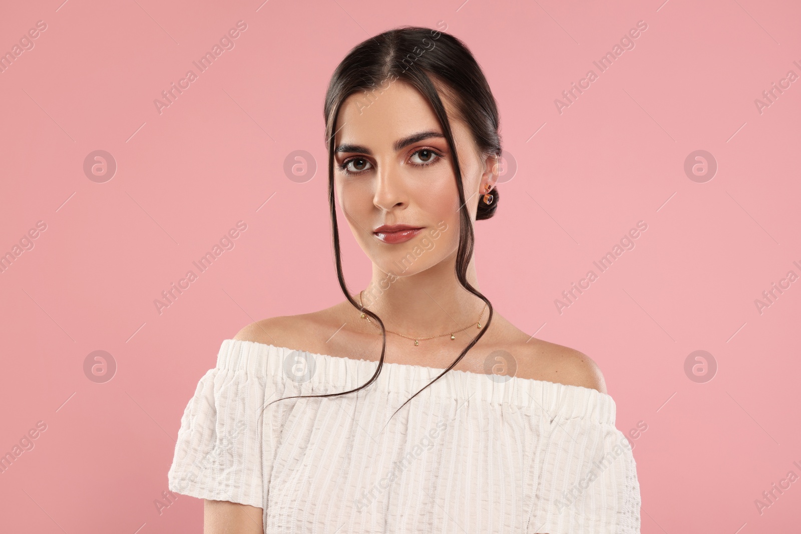 Photo of Beautiful woman with elegant jewelry on pink background