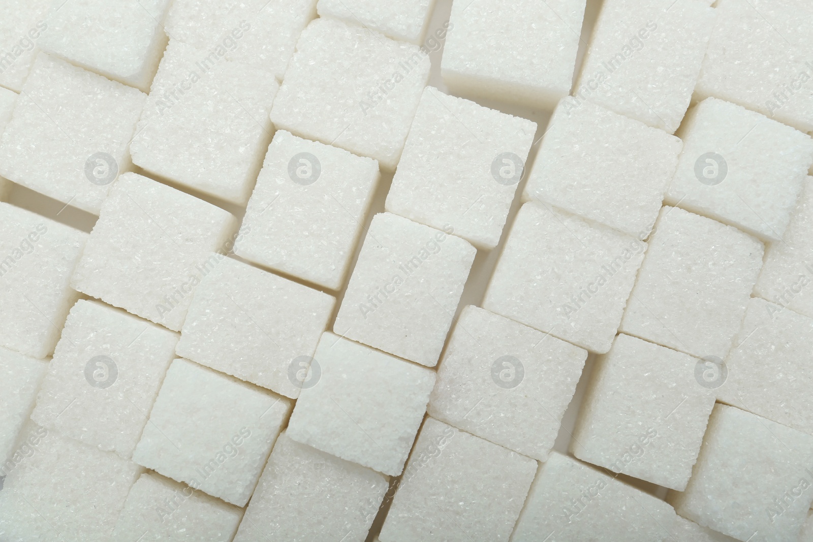 Photo of White sugar cubes as background, top view