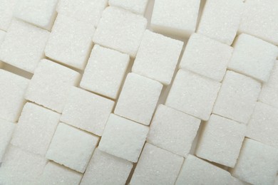 White sugar cubes as background, top view