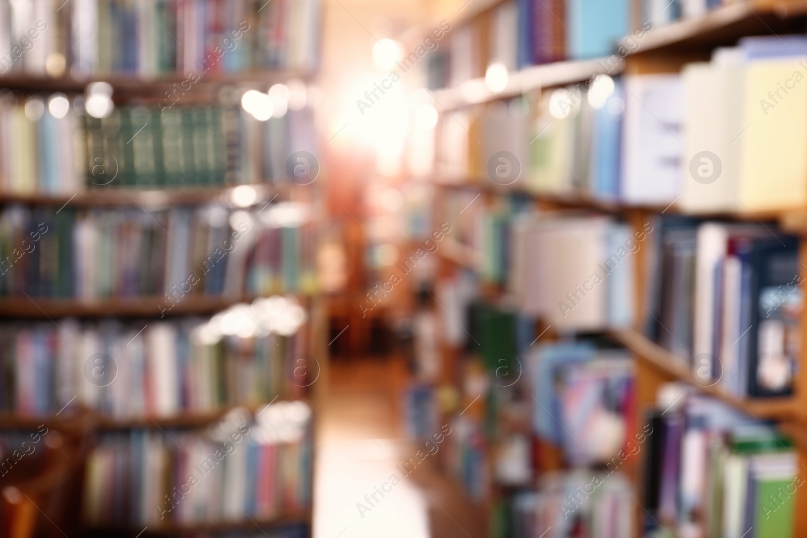 Photo of Blurred view of different books on shelves in library