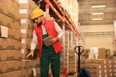 Man with tablet working at warehouse. Logistics center