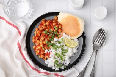 Photo of Delicious chickpea curry with rice served on white tiled table, flat lay