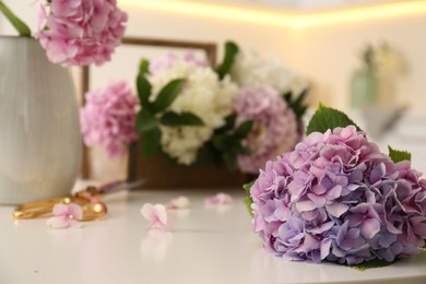 Closeup view of hydrangea flowers on white table, space for text. Interior design element