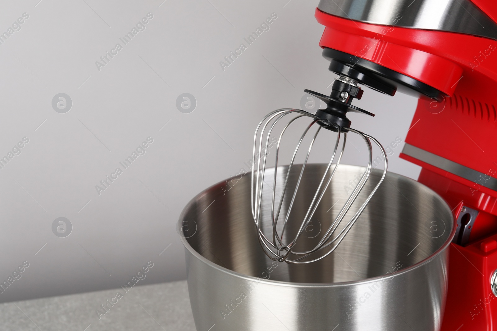 Photo of Modern red stand mixer on light gray background, space for text