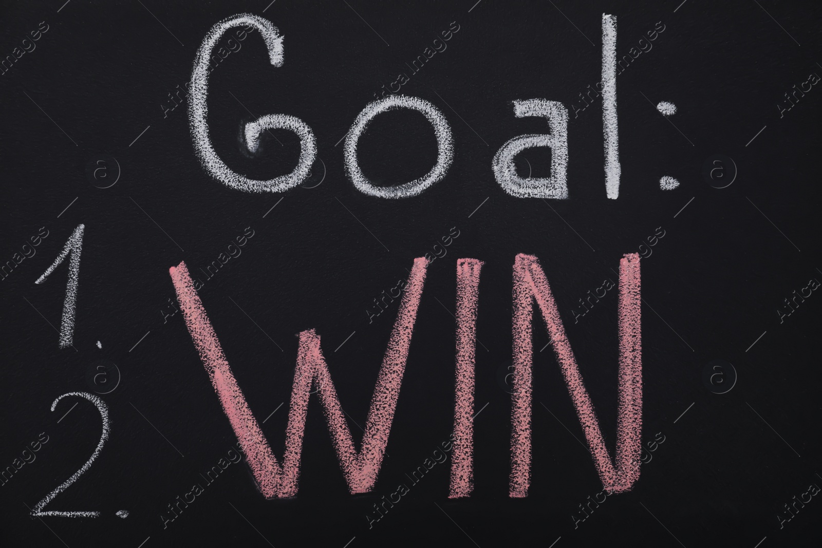 Photo of Motivational inscription written with chalk on blackboard. Victory concept