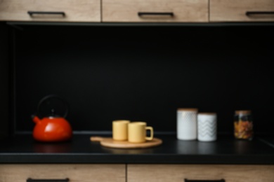 Photo of Blurred view of kitchen interior with modern furniture