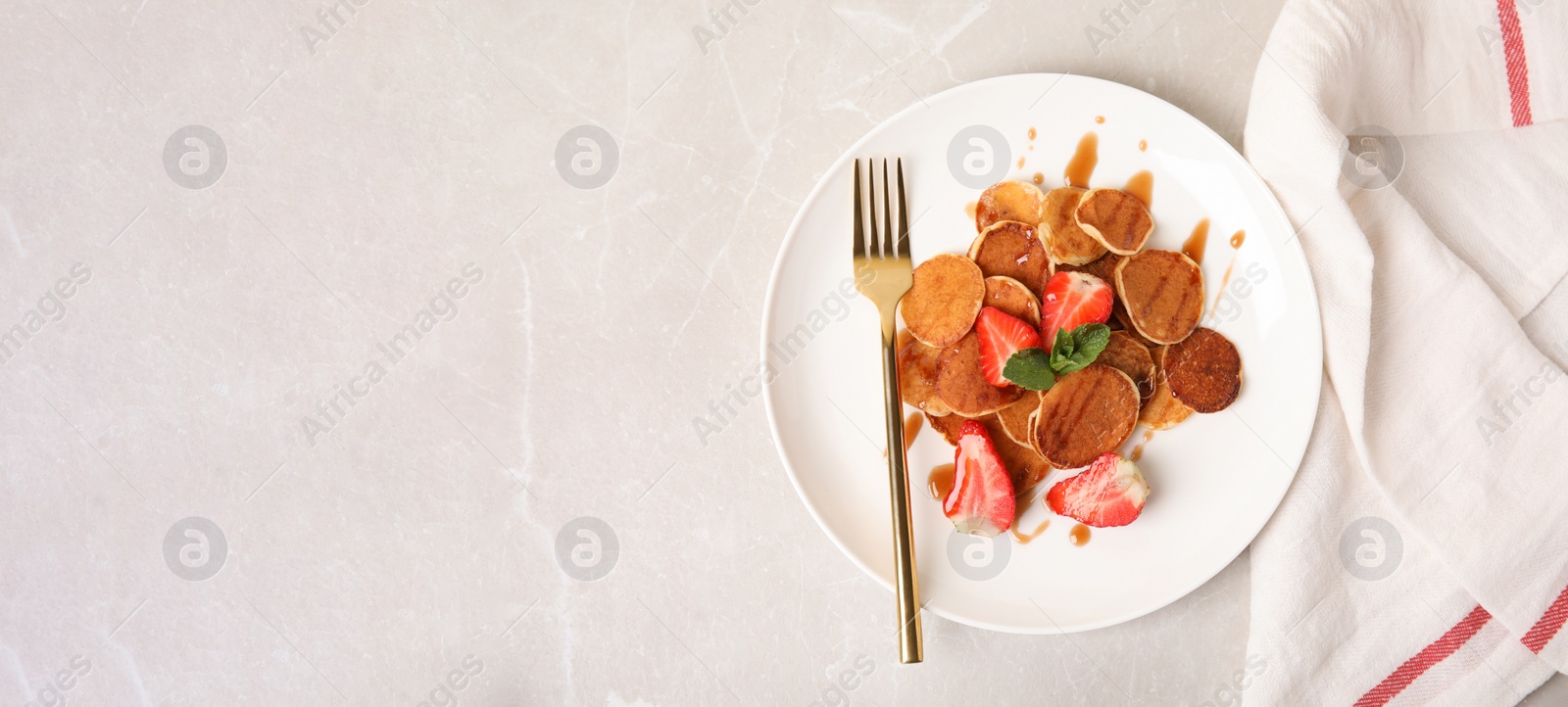 Image of Cereal pancakes with strawberries on light grey marble table, flat lay with space for text. Banner design