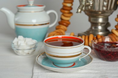 Composition with delicious ring shaped Sushki (dry bagels) and tea on white wooden table indoors