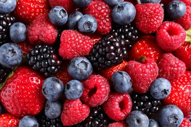 Photo of Different fresh ripe berries as background, top view