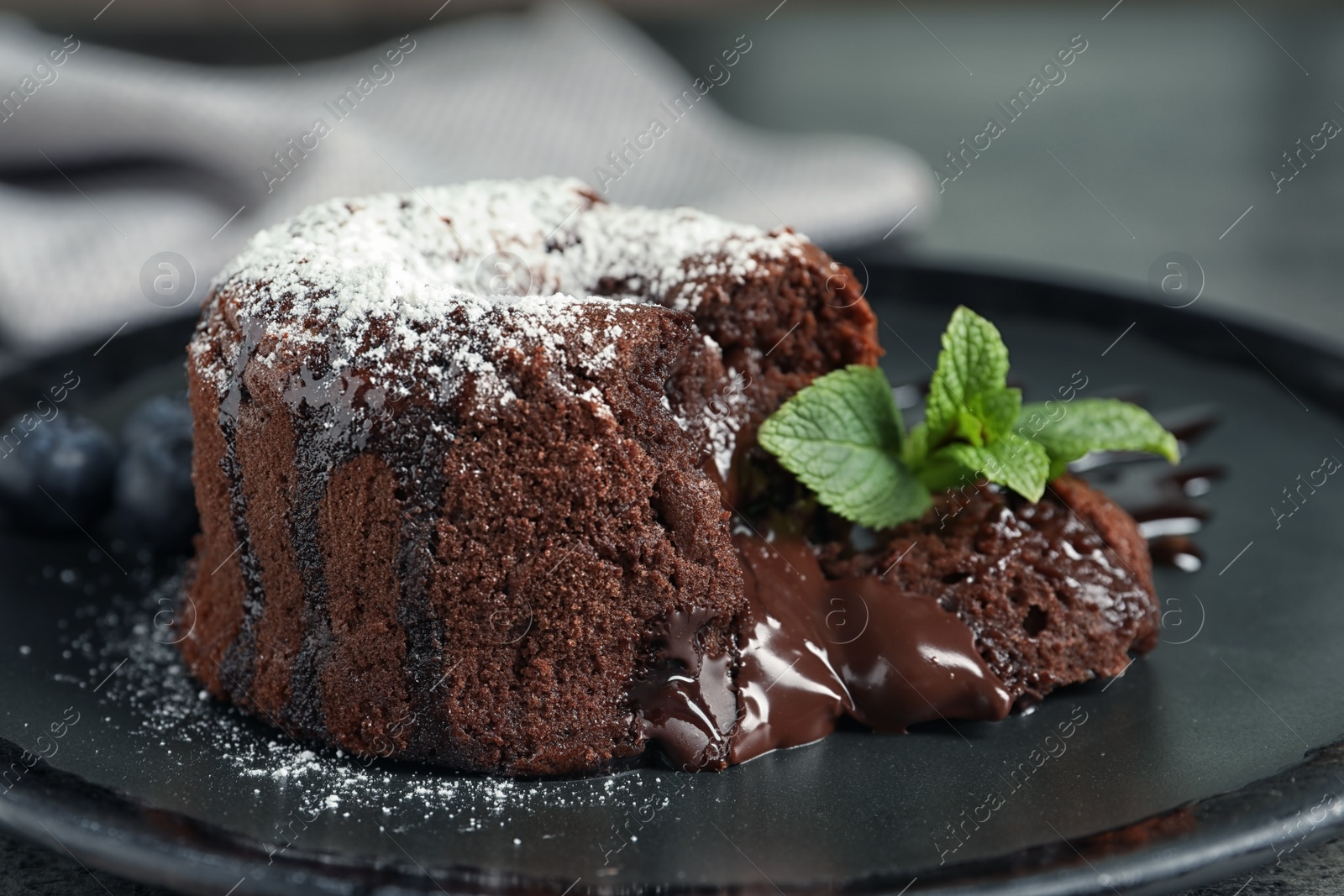 Photo of Delicious fresh fondant with hot chocolate and blueberries served on plate. Lava cake recipe