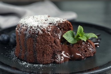 Photo of Delicious fresh fondant with hot chocolate and blueberries served on plate. Lava cake recipe