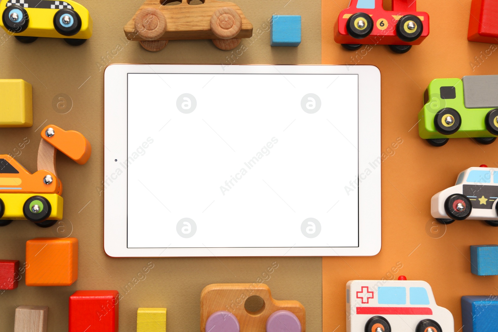 Photo of Modern tablet and toys on color background, flat lay. Space for text