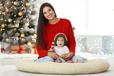 Mother and her cute baby at home. Christmas celebration