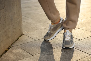 Photo of Man wearing stylish sneakers outdoors, closeup. Space for text