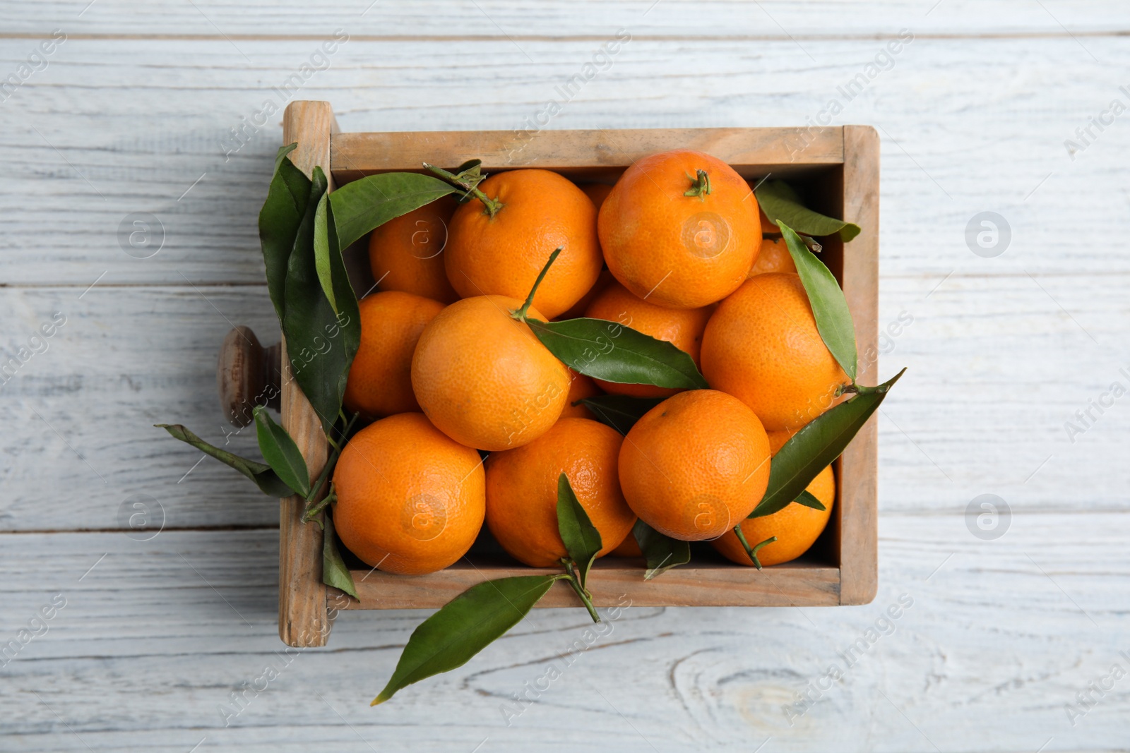 Photo of Crate with fresh ripe tangerines on wooden background, top view