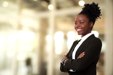 Lawyer, consultant, business owner. Confident woman smiling indoors, space for text