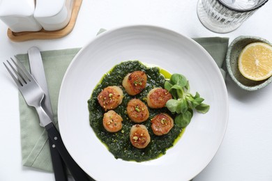 Photo of Delicious fried scallops in bowl served on white table, flat lay