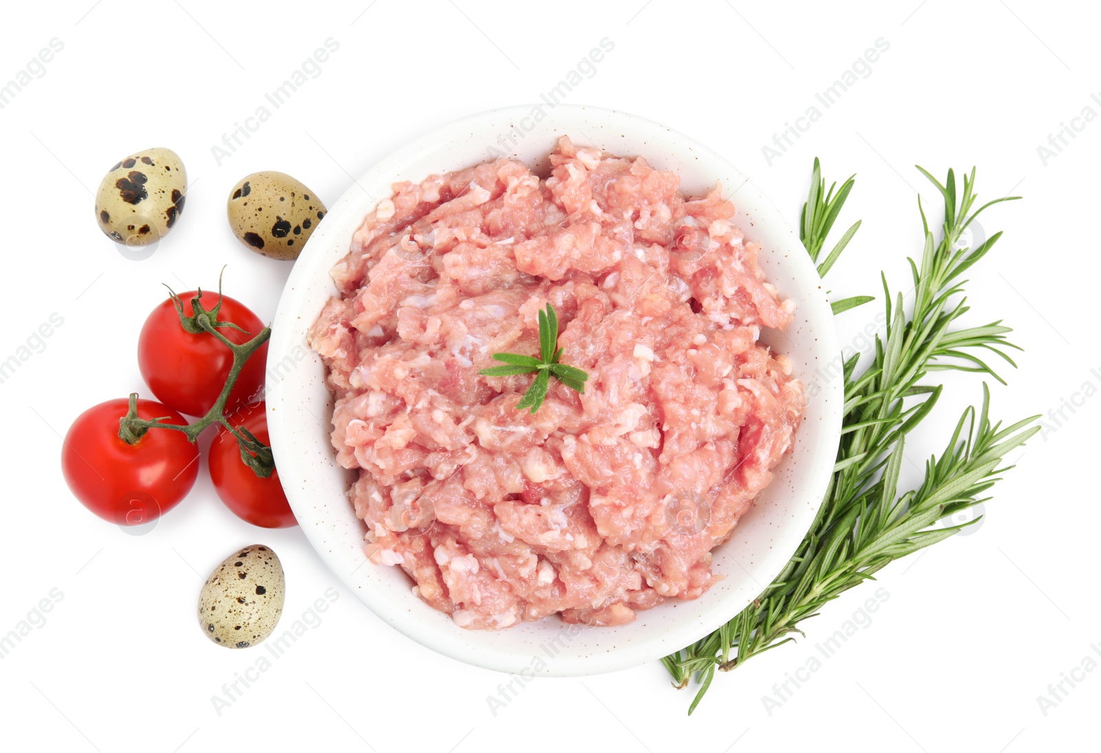 Photo of Raw chicken minced meat with rosemary, quail eggs and tomatoes on white background, top view