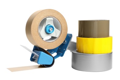 Dispenser and rolls of adhesive tape on white background