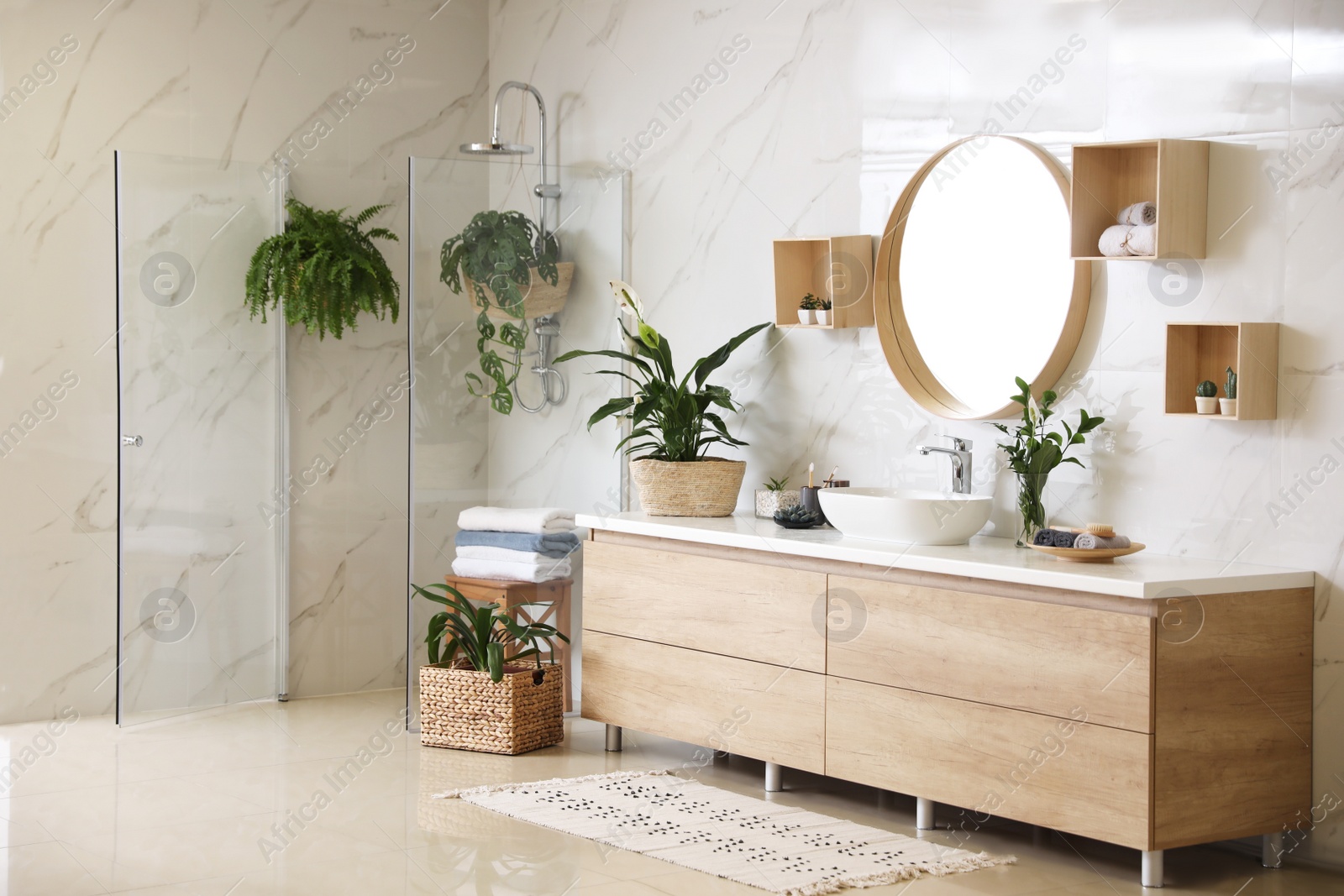 Photo of Green plants in elegant modern bathroom. Interior design