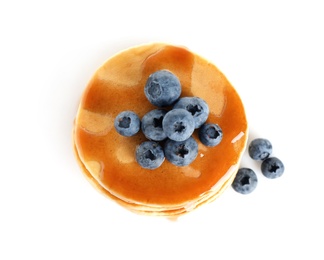 Delicious pancakes with fresh blueberries and syrup on white background, top view