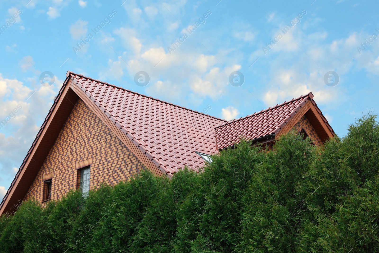 Photo of Beautiful house with red roof against blue sky