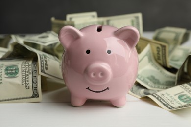 Money exchange. Dollar banknotes and piggy bank on white wooden background, closeup