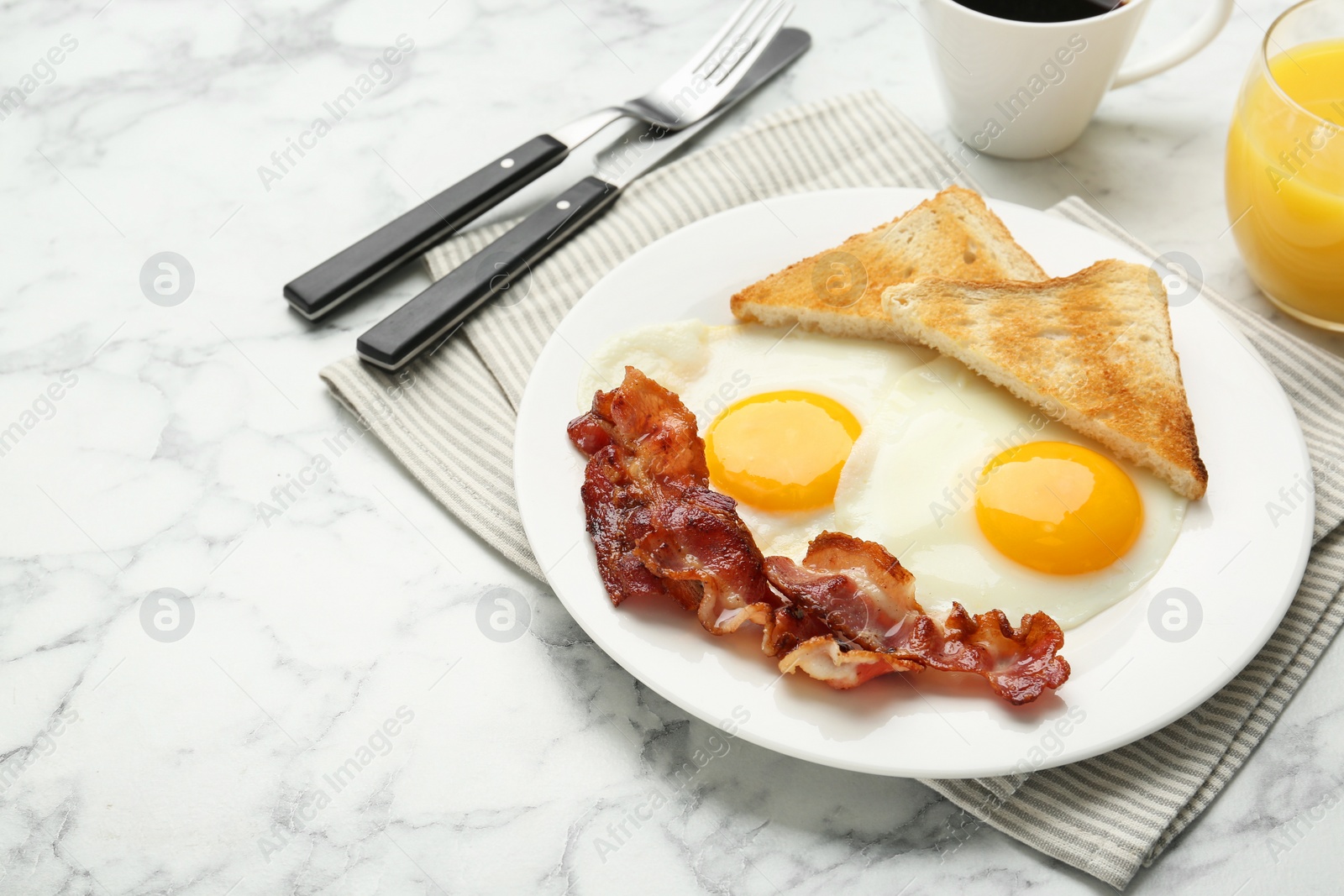 Photo of Delicious breakfast with sunny side up eggs served on white marble table