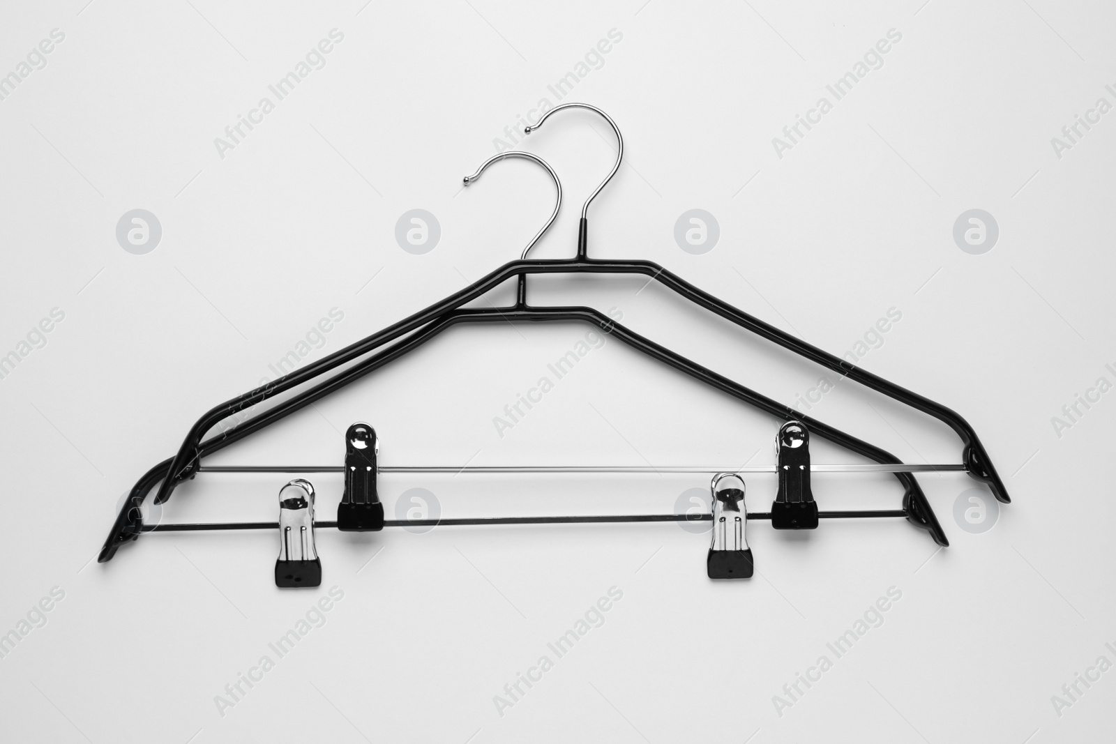 Photo of Empty hangers with clips on light grey background, flat lay