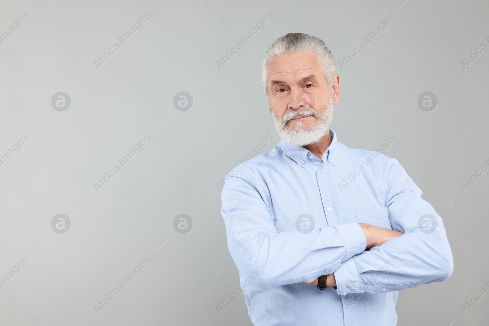 Photo of Portrait of handsome senior man on light grey background. Space for text