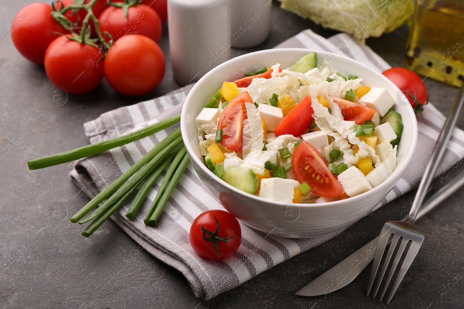 Photo of Tasty salad with Chinese cabbage served on grey table