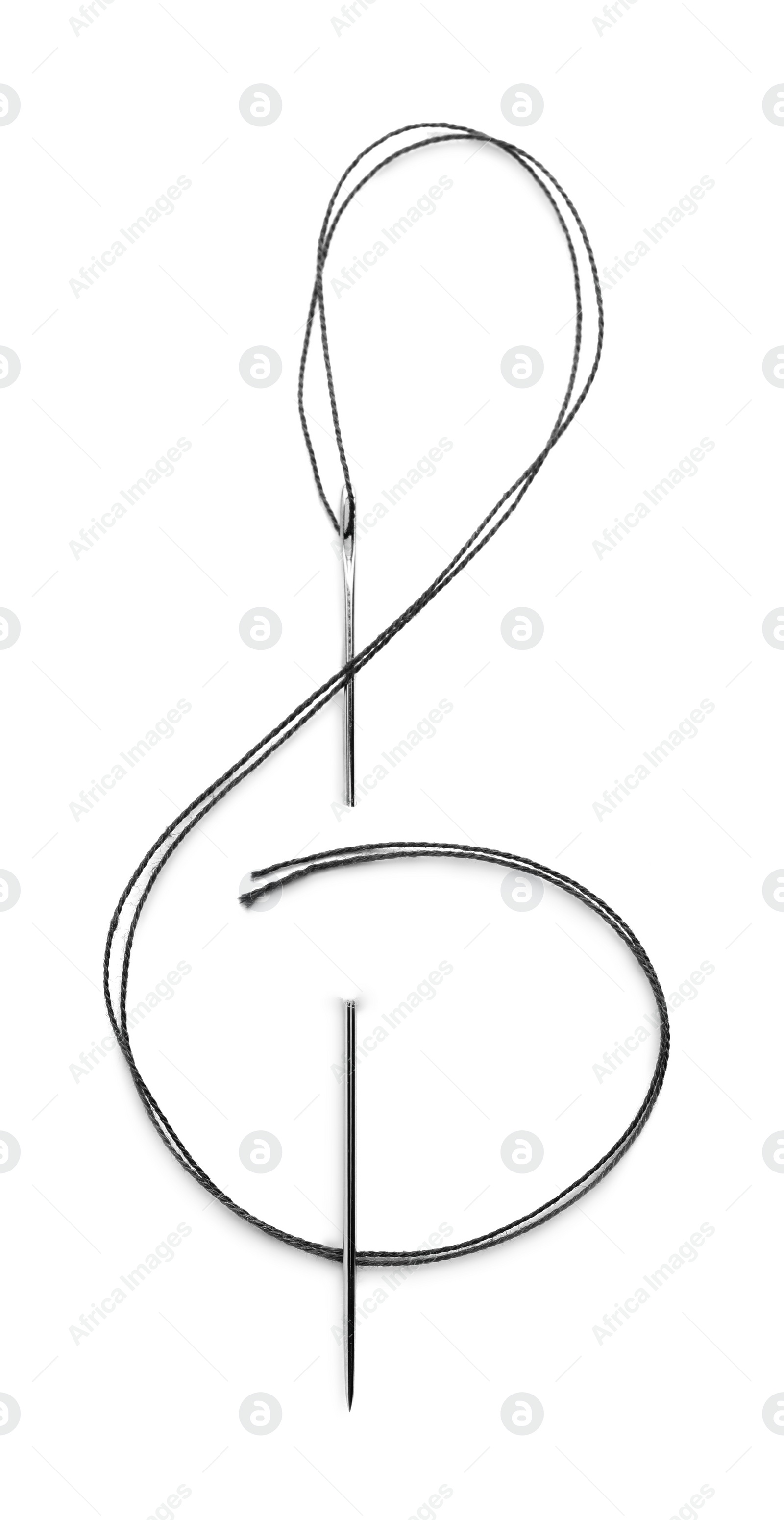 Photo of Shape of treble clef made with sewing needle and thread isolated on white, top view