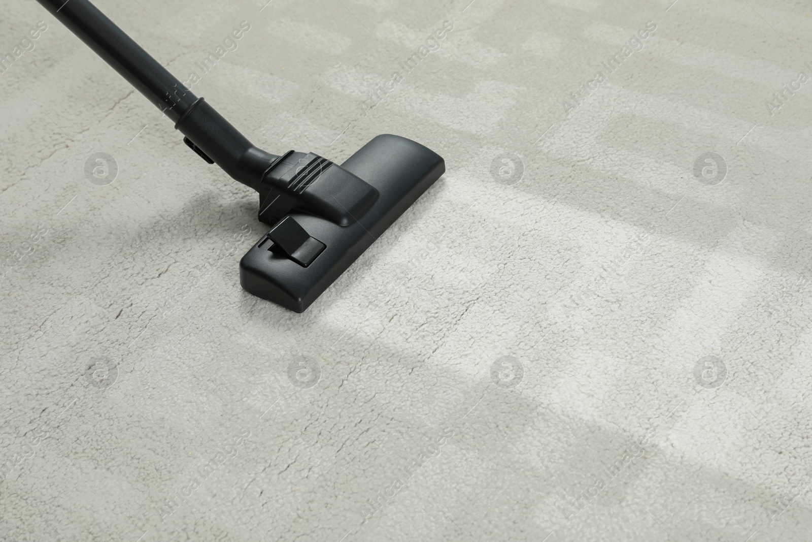 Image of Hoovering carpet with vacuum cleaner, space for text. Clean trace on dirty surface