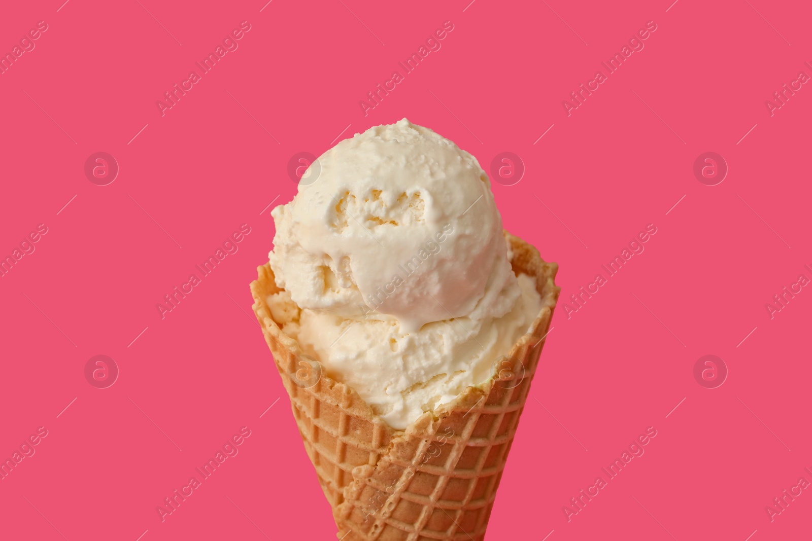 Photo of Delicious ice cream in waffle cone on pink background, closeup