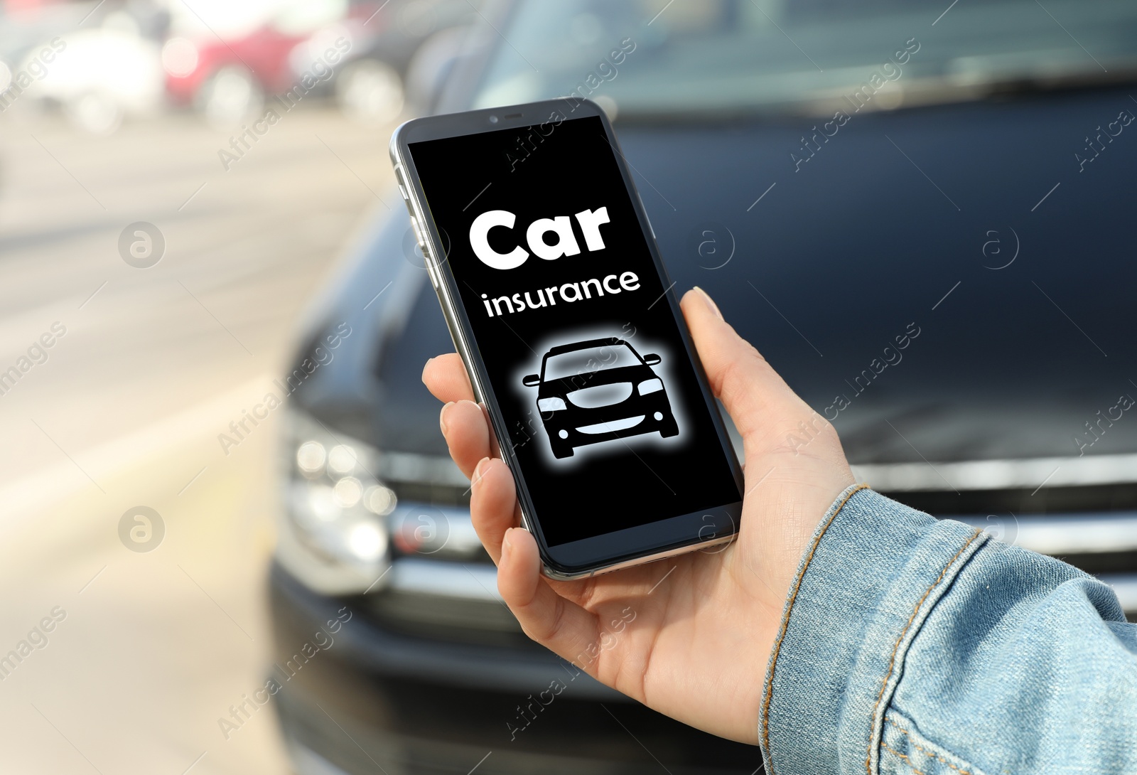 Image of Woman using phone for car insurance outdoors, closeup