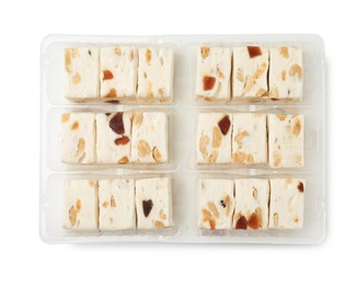 Photo of Plastic containers with pieces of nougat on white background, top view