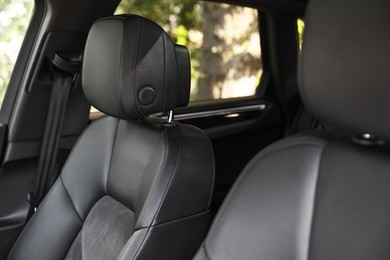 Clean leather seats inside of modern black car