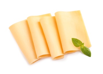 Photo of Slices of tasty cheese with basil on white background, top view