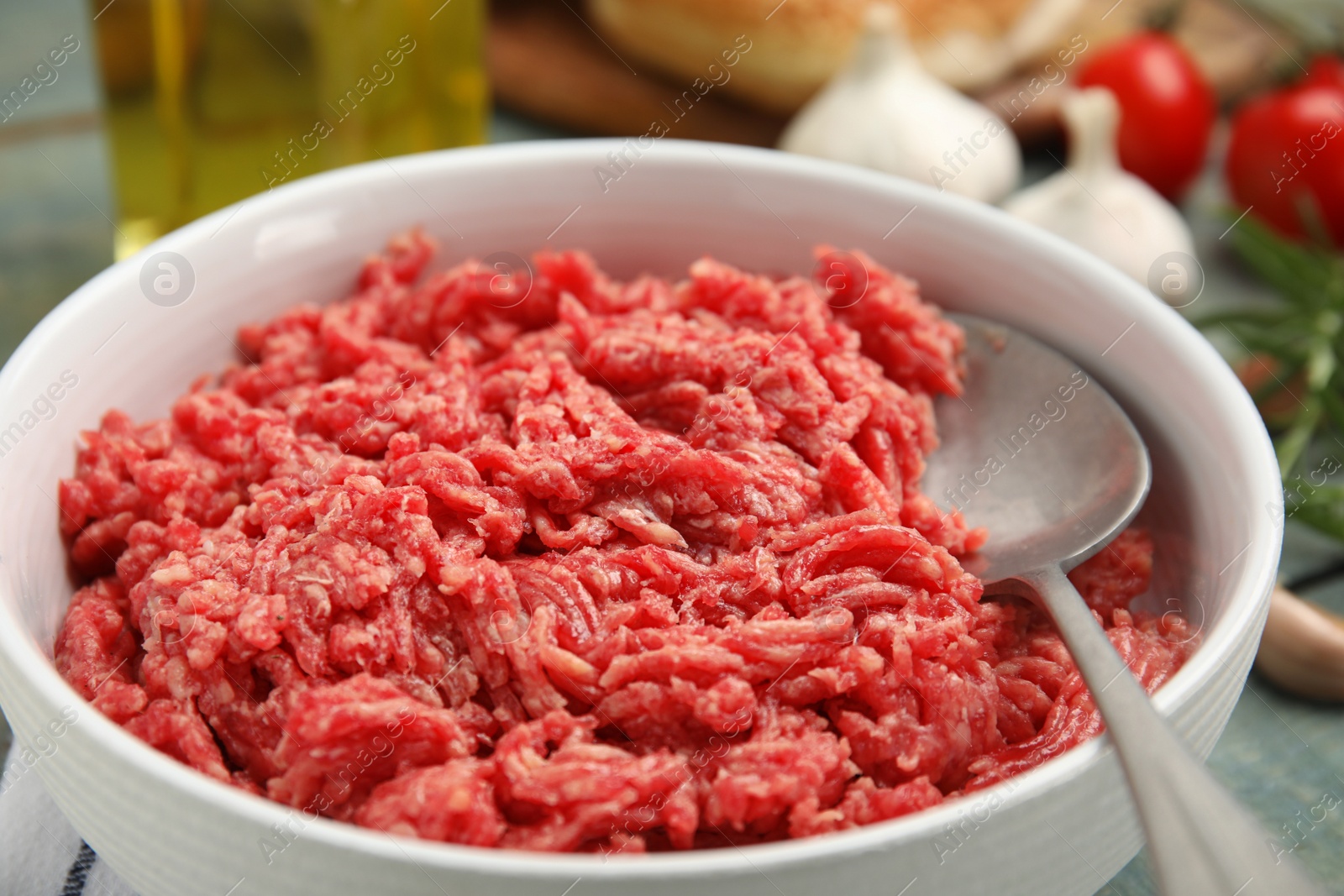 Photo of Fresh minced meat in bowl on table, closeup