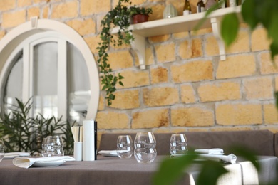 Photo of Table with plates and empty glasses in cafe