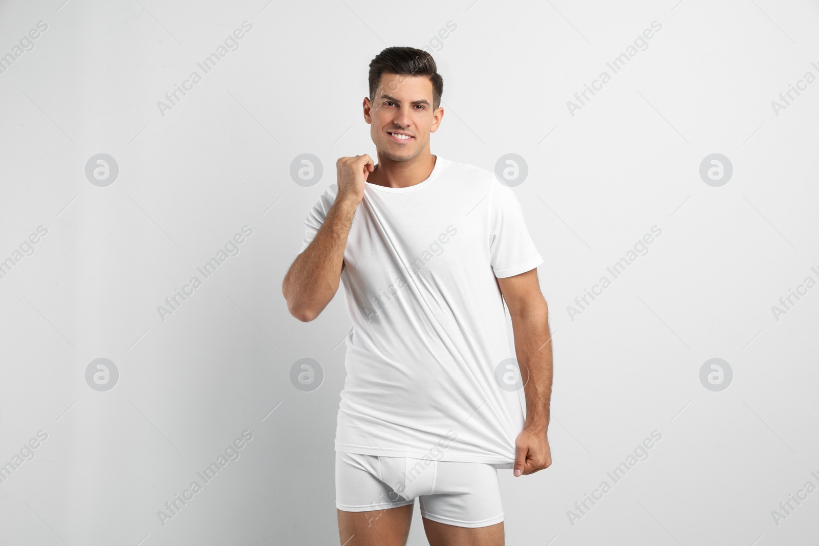 Photo of Handsome man in underwear and t-shirt on white background