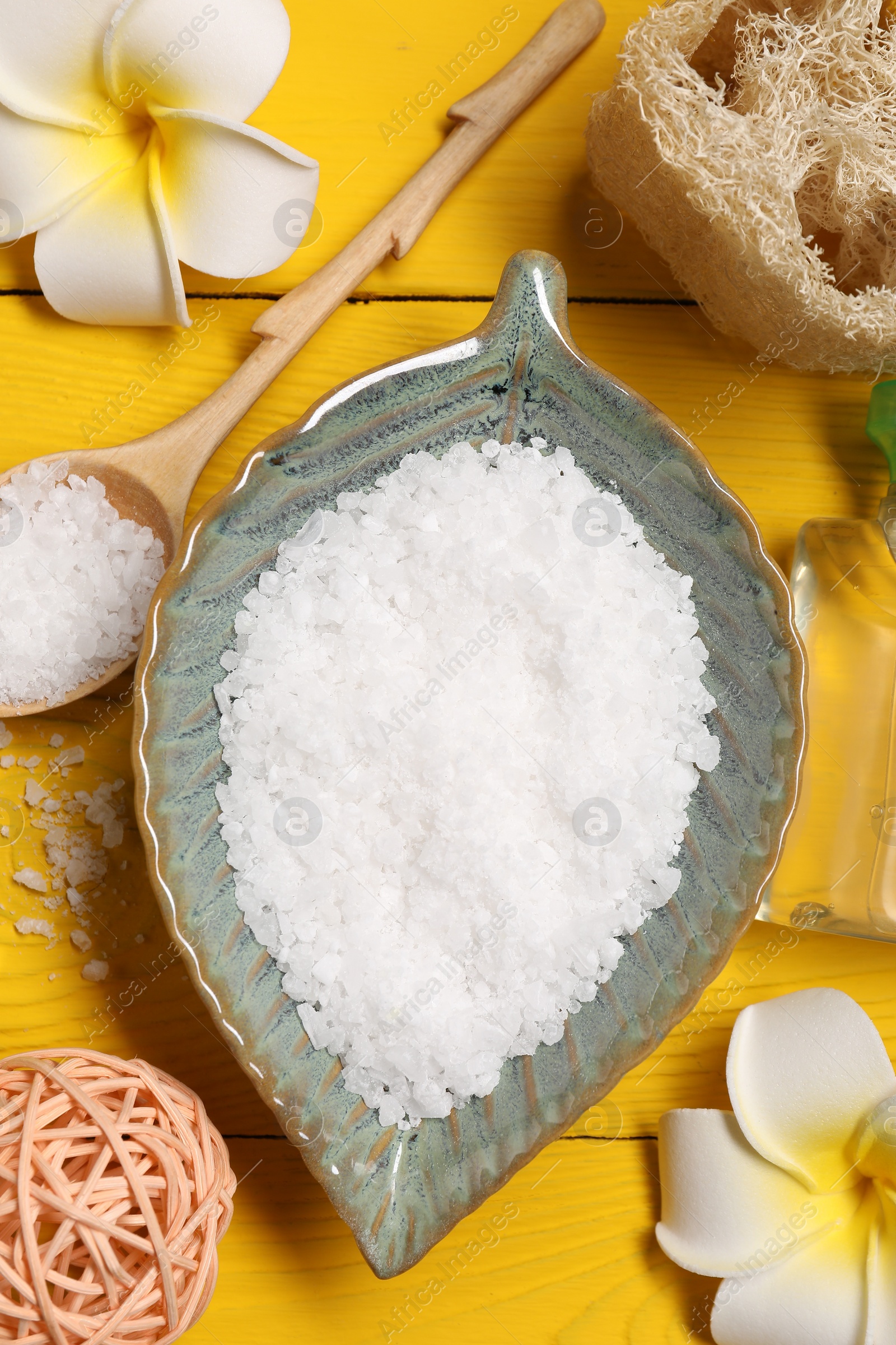 Photo of Flat lay composition with natural sea salt on yellow wooden table