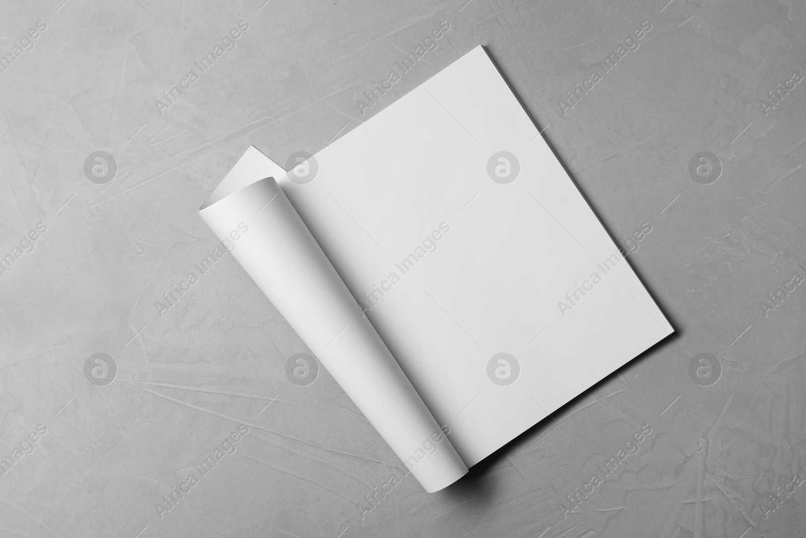 Photo of Blank paper sheet on grey textured background, top view. Mockup for design