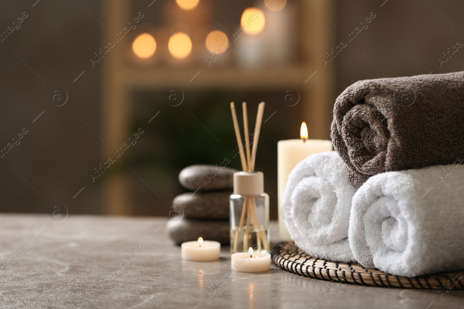 Photo of Beautiful composition with spa stones on grey marble table, closeup. Space for text