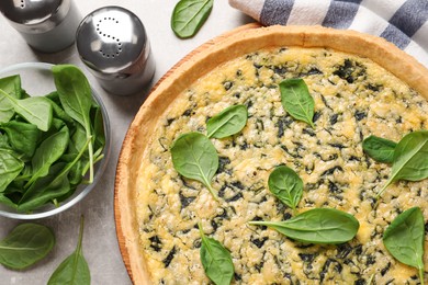 Photo of Delicious homemade spinach pie on light grey table, flat lay